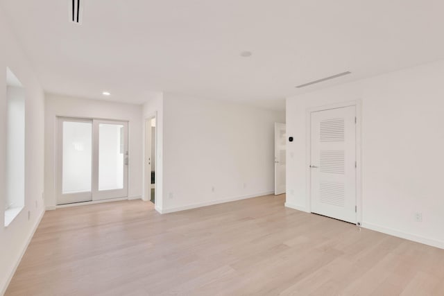 spare room featuring light wood-type flooring