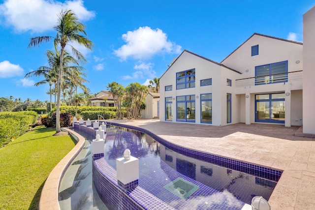 view of swimming pool featuring a patio and a yard