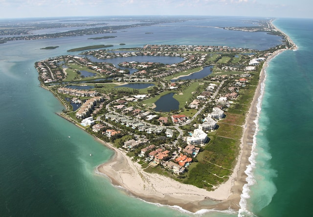 birds eye view of property with a beach view and a water view