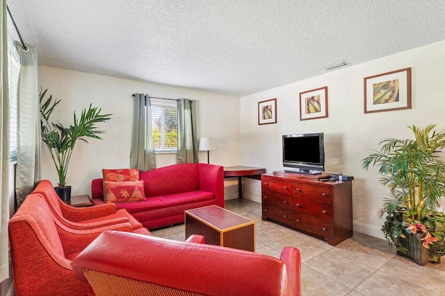 tiled living room with a textured ceiling