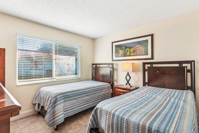 tiled bedroom with a textured ceiling