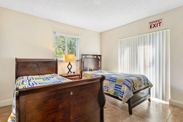 tiled bedroom with a textured ceiling