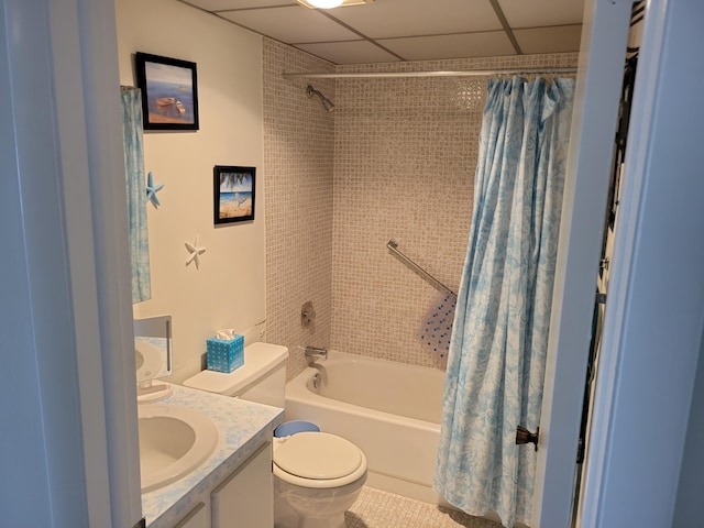 full bathroom featuring vanity, a drop ceiling, shower / tub combo with curtain, and toilet