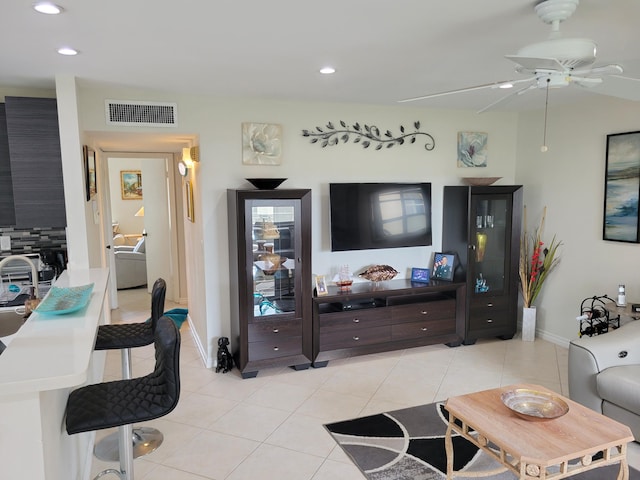 tiled living room with ceiling fan