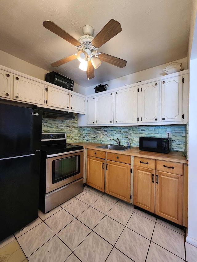 kitchen with ceiling fan, black appliances, sink, light tile floors, and tasteful backsplash