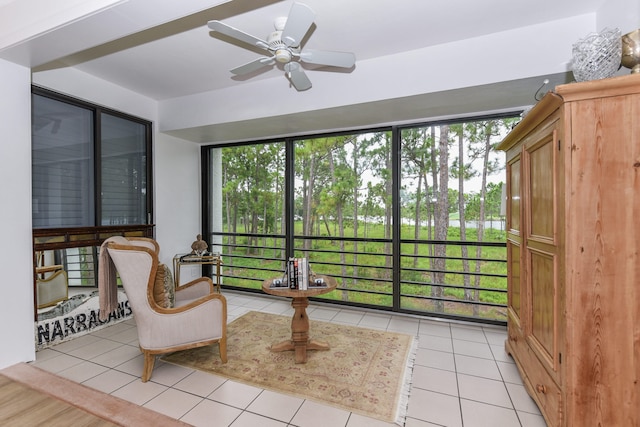 sunroom featuring ceiling fan and plenty of natural light