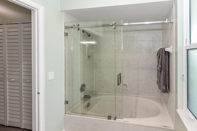 bathroom with shower / bath combination with glass door