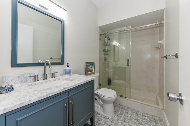 bathroom featuring toilet, vanity, and walk in shower