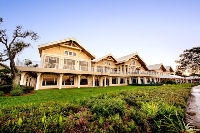 rear view of property with a lawn