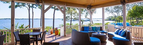 wooden deck with a water view, an outdoor hangout area, and a gazebo