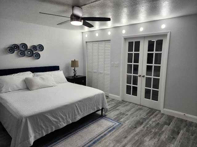 bedroom with french doors, a textured ceiling, ceiling fan, hardwood / wood-style floors, and a closet