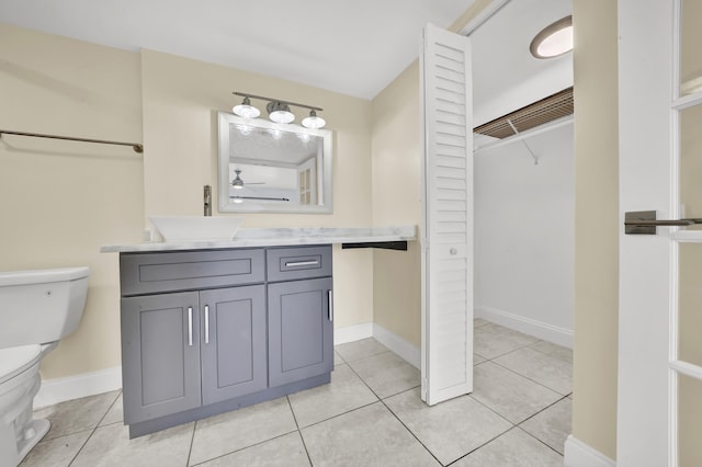 bathroom with tile patterned floors, vanity, and toilet