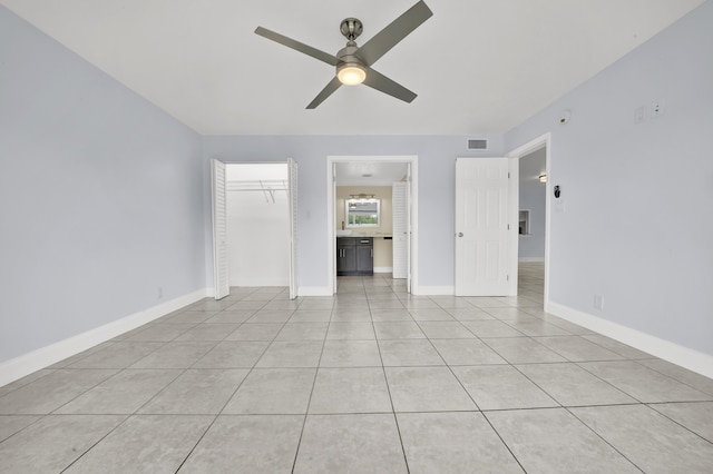 interior space featuring light tile patterned floors and ceiling fan