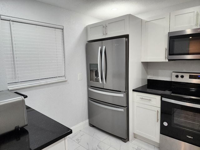 kitchen featuring white cabinetry and stainless steel appliances