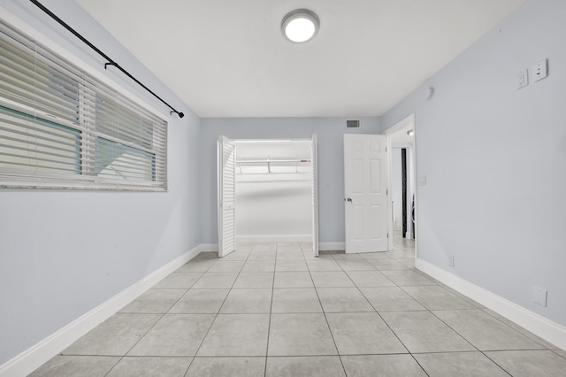 spare room with light tile patterned floors