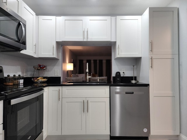 kitchen with white cabinetry, sink, and appliances with stainless steel finishes