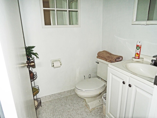 bathroom featuring vanity, tile flooring, and toilet