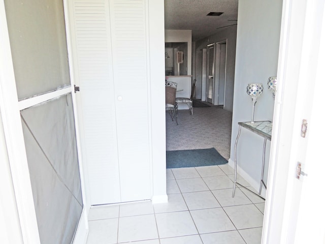 hallway featuring light tile floors