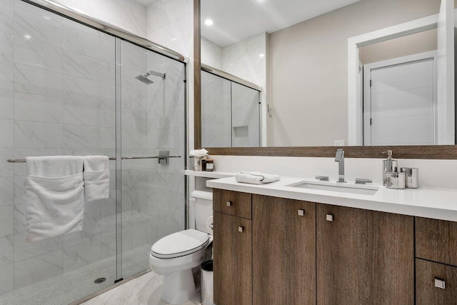 bathroom with vanity, walk in shower, and toilet