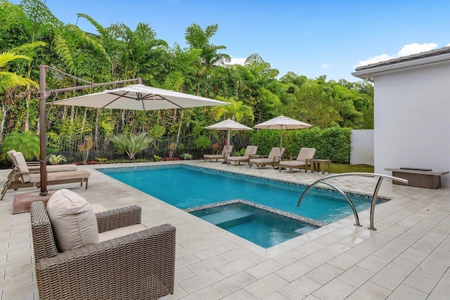 view of swimming pool with a patio and an in ground hot tub