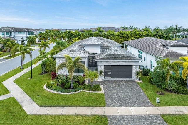 view of front of house featuring a garage and a front lawn