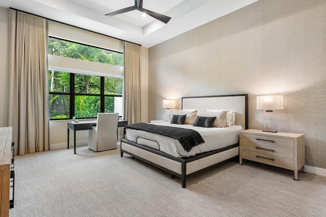 bedroom featuring light colored carpet and ceiling fan