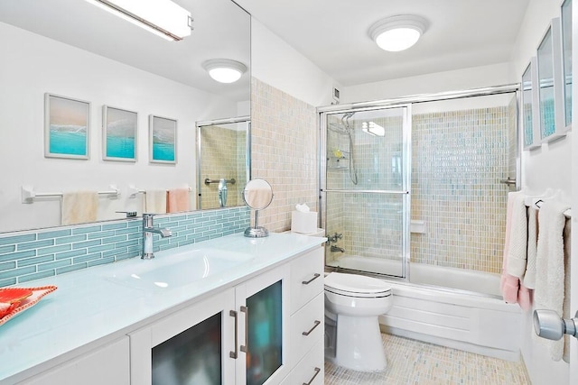 full bath with toilet, enclosed tub / shower combo, tile patterned flooring, vanity, and backsplash