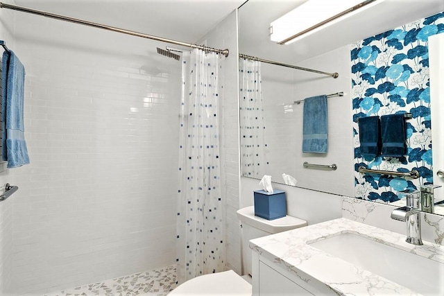 full bath with toilet, tiled shower, visible vents, and vanity