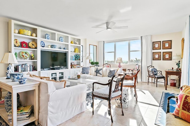 living area with ceiling fan and light tile patterned floors