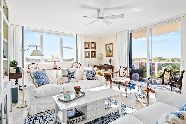 living room featuring a ceiling fan and floor to ceiling windows