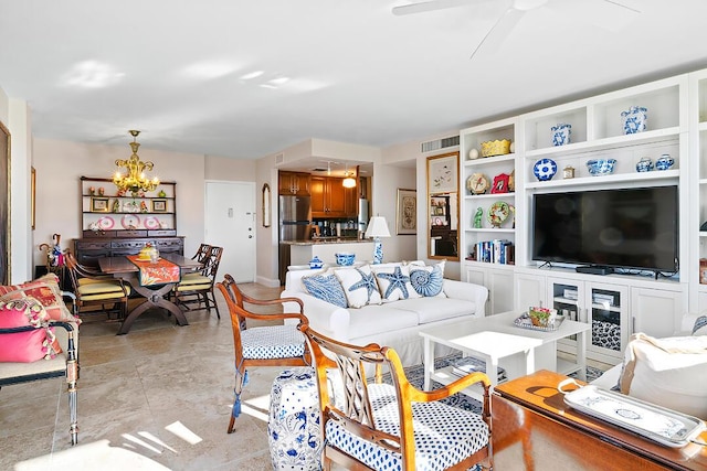 living room with visible vents and ceiling fan with notable chandelier