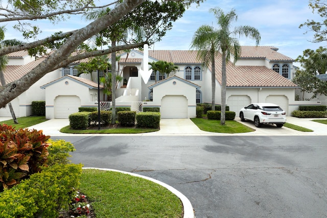 mediterranean / spanish-style house with a garage