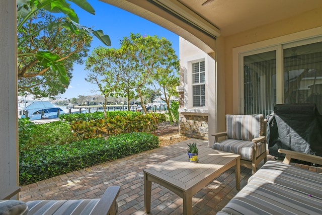 view of patio / terrace with area for grilling and a water view