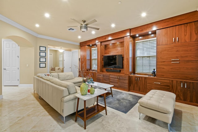 living room with crown molding and ceiling fan