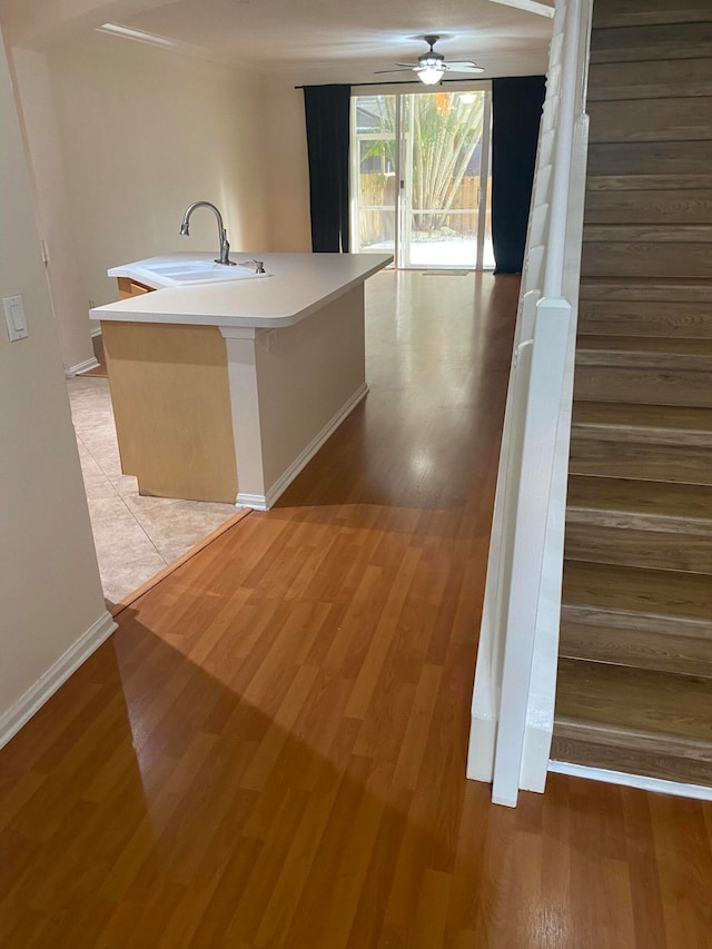 corridor featuring sink and light tile flooring