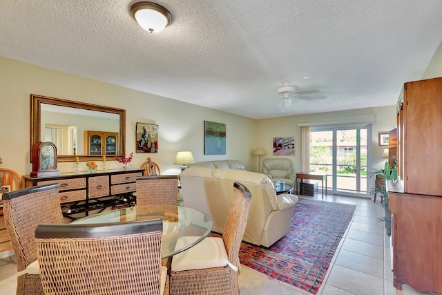 living room featuring light tile patterned floors, a textured ceiling, and ceiling fan