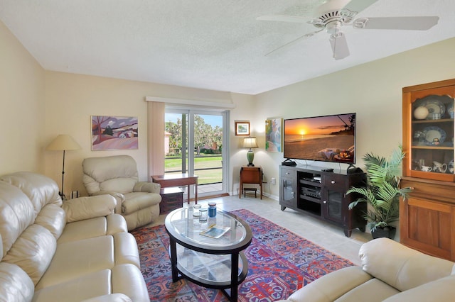 tiled living room with ceiling fan and a textured ceiling