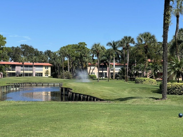 view of property's community featuring a yard and a water view