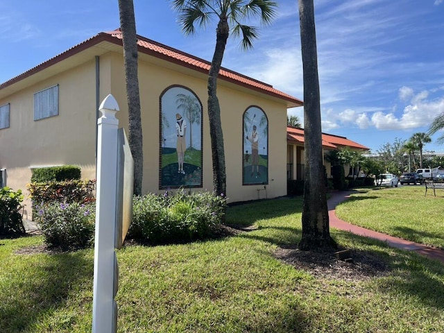 view of side of home featuring a lawn