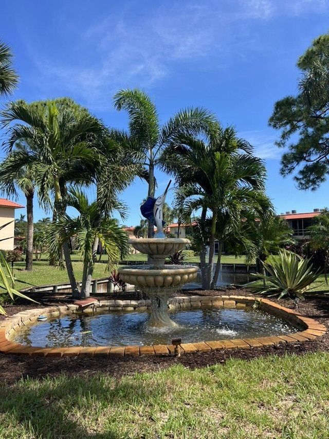 view of property's community featuring a garden pond