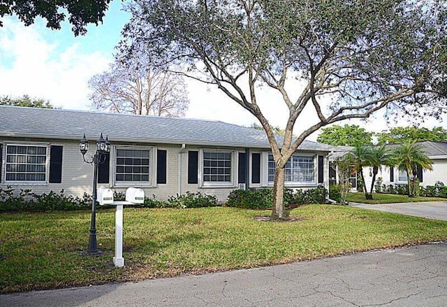 ranch-style house with a front lawn