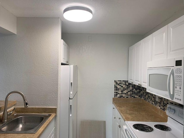 kitchen with tasteful backsplash, white appliances, white cabinetry, and sink