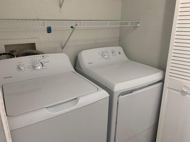 laundry area featuring washer hookup and washing machine and clothes dryer