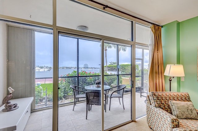 sunroom featuring a water view