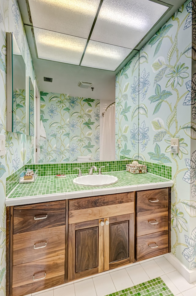 bathroom with tile patterned floors, vanity, and curtained shower