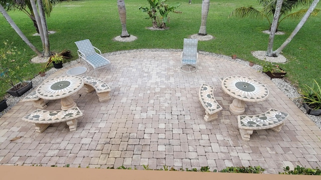 view of property's community with a lawn and a patio