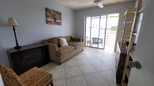 tiled living room with ceiling fan