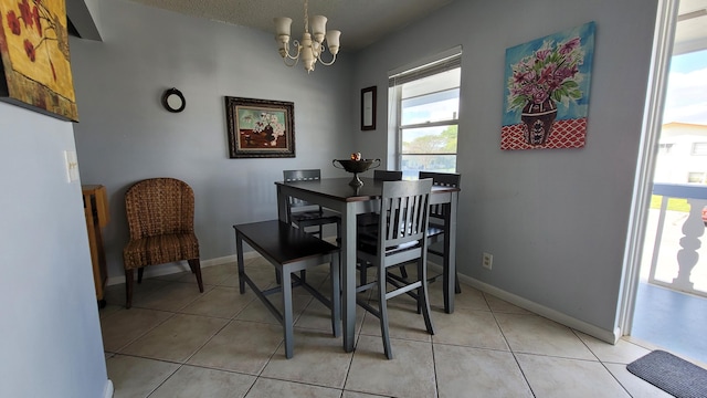 tiled dining area with a chandelier and a wealth of natural light