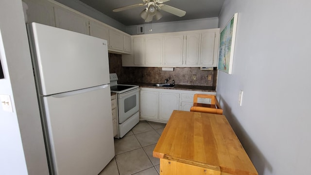 kitchen with white appliances, ceiling fan, light tile floors, white cabinets, and backsplash