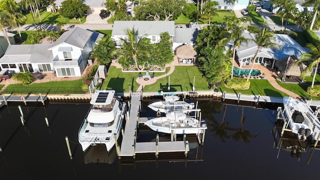 view of dock with a water view and a lawn